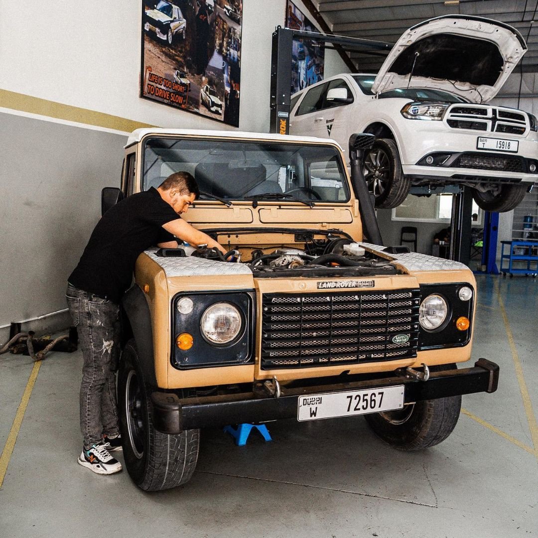 Technician working on a Land Rover Defender inside the workshop