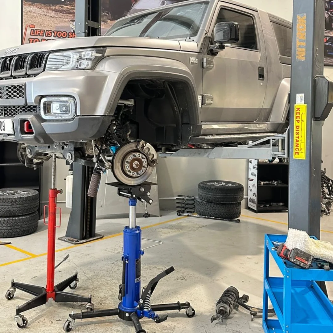 Vehicle raised in the RHP GARAGE workshop with a wheel removed for suspension service
